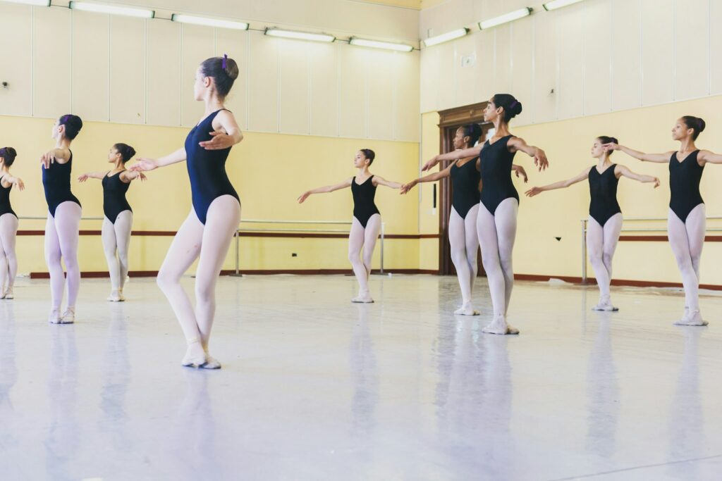 Group of young ballet students dancing in a bright studio